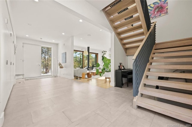 tiled entryway with stairway, recessed lighting, and baseboards