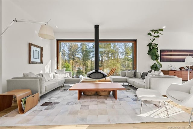 living area with recessed lighting and a wood stove