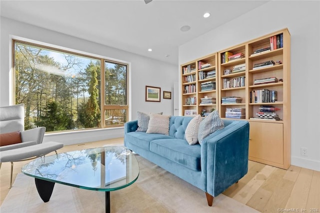 living room with light wood finished floors and recessed lighting