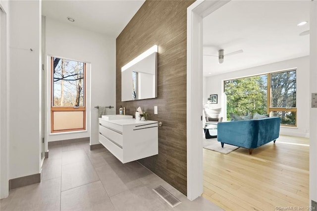 bathroom featuring vanity, baseboards, ceiling fan, and recessed lighting