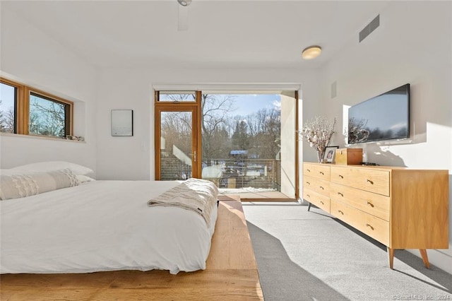 carpeted bedroom featuring access to outside
