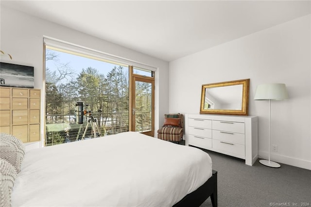 bedroom with baseboards and dark carpet