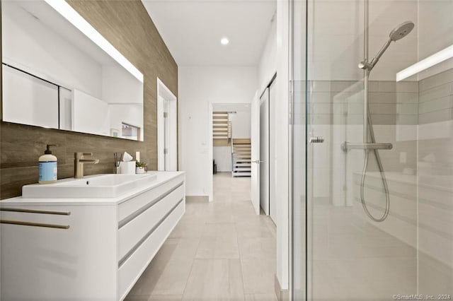 bathroom featuring a stall shower, vanity, recessed lighting, tile patterned floors, and backsplash