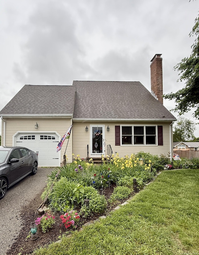 58 Spruceland Rd, Enfield, CT 06082 - cape cod-style house with an attached garage, a chimney, asphalt driveway, and a shingled roof