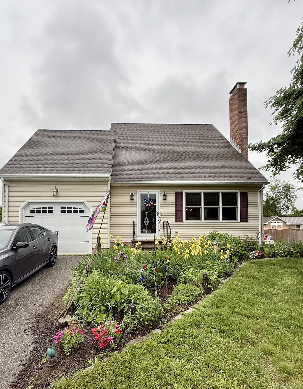 58 Spruceland Rd, Enfield, CT 06082 - cape cod house featuring an attached garage, a chimney, asphalt driveway, and roof with shingles