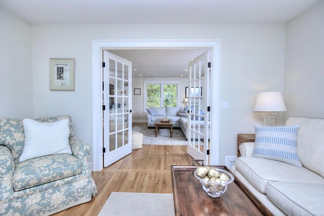 127 College Park Dr, Fairfield, CT 06824 - living area with light wood-style flooring and french doors