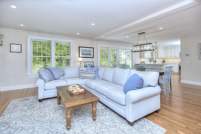 127 College Park Dr, Fairfield, CT 06824 - living area with light wood-style floors, baseboards, healthy amount of natural light, recessed lighting, and a chandelier