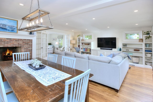 127 College Park Dr, Fairfield, CT 06824 - dining area featuring light wood-style flooring, a fireplace, healthy amount of natural light, recessed lighting, and french doors
