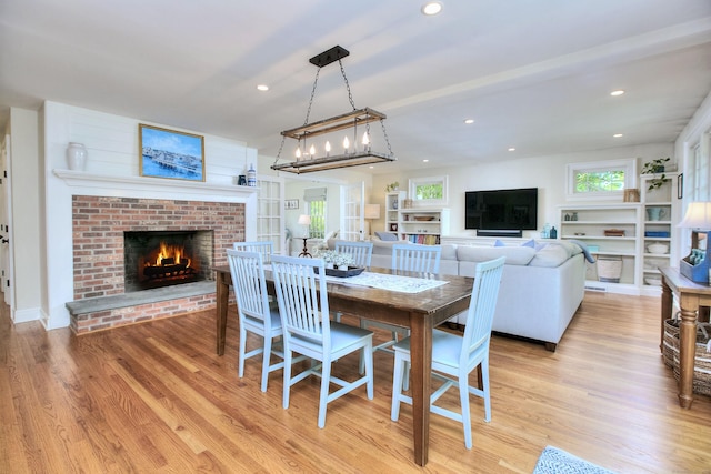 127 College Park Dr, Fairfield, CT 06824 - dining space with a brick fireplace, light wood finished floors, and recessed lighting