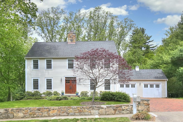 127 College Park Dr, Fairfield, CT 06824 - colonial inspired home with a chimney, decorative driveway, a garage, and a front lawn