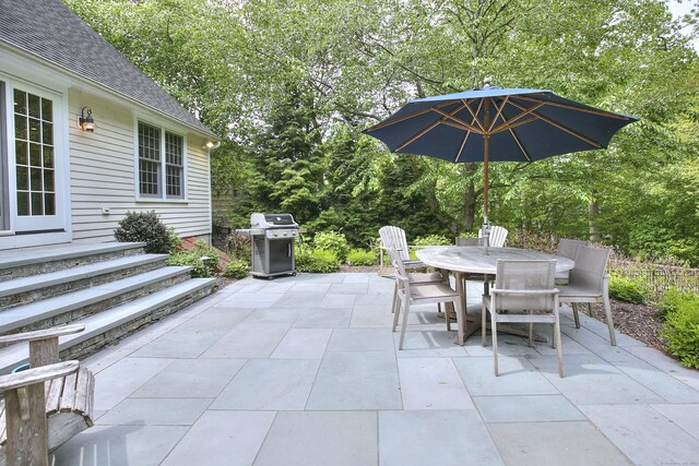 127 College Park Dr, Fairfield, CT 06824 - view of patio featuring a grill, outdoor dining area, and view of wooded area