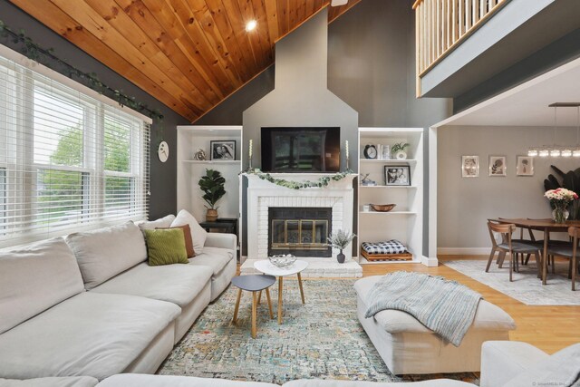 36 Overlook Dr Unit 36, Monroe, CT 06468 - living area featuring wood ceiling, wood finished floors, baseboards, lofted ceiling, and a brick fireplace