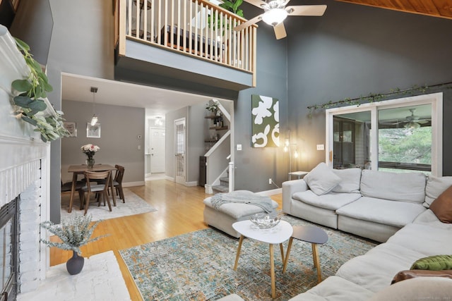 36 Overlook Dr Unit 36, Monroe, CT 06468 - living area featuring high vaulted ceiling, stairs, ceiling fan, wood finished floors, and a fireplace