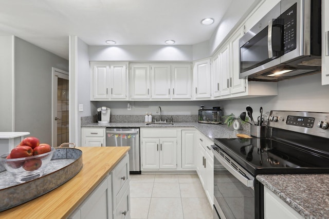 36 Overlook Dr Unit 36, Monroe, CT 06468 - kitchen with stainless steel appliances, a sink, white cabinets, light tile patterned floors, and recessed lighting