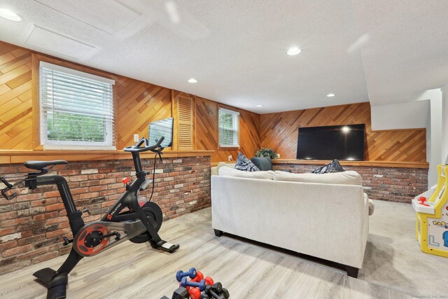 36 Overlook Dr Unit 36, Monroe, CT 06468 - exercise area with healthy amount of natural light, wood walls, brick wall, wood finished floors, and recessed lighting