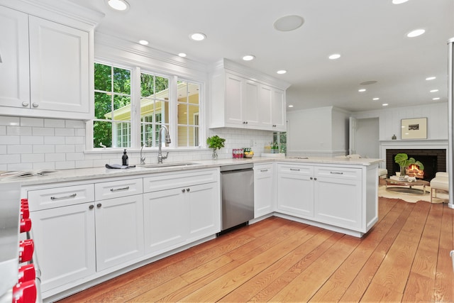 26 Heritage Ln, Weston, CT 06883 - kitchen with stainless steel dishwasher, a sink, white cabinets, a peninsula, and crown molding