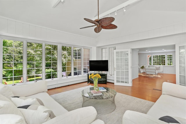 26 Heritage Ln, Weston, CT 06883 - living area with track lighting, a ceiling fan, wood finished floors, a baseboard heating unit, and high vaulted ceiling