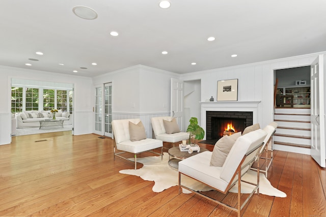 26 Heritage Ln, Weston, CT 06883 - living area featuring crown molding, hardwood / wood-style flooring, a brick fireplace, a decorative wall, and recessed lighting