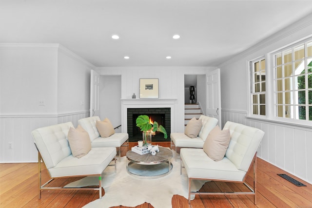 26 Heritage Ln, Weston, CT 06883 - living room featuring crown molding, hardwood / wood-style flooring, recessed lighting, a brick fireplace, and wainscoting