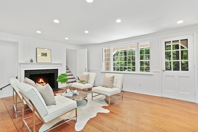 26 Heritage Ln, Weston, CT 06883 - living room featuring crown molding, a brick fireplace, light wood-style floors, and recessed lighting