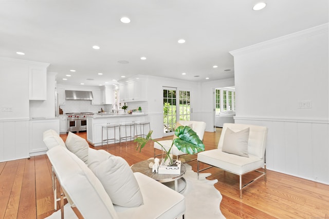 26 Heritage Ln, Weston, CT 06883 - living area with light wood-style floors, ornamental molding, wainscoting, and recessed lighting
