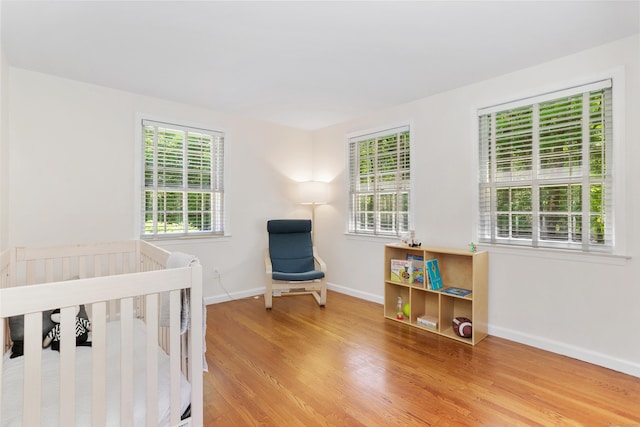 26 Heritage Ln, Weston, CT 06883 - bedroom with multiple windows, wood finished floors, and baseboards