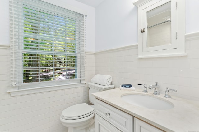 26 Heritage Ln, Weston, CT 06883 - bathroom featuring tile walls, vanity, toilet, and a wainscoted wall