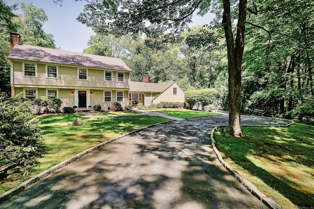 26 Heritage Ln, Weston, CT 06883 - view of front of property featuring a front yard and a chimney