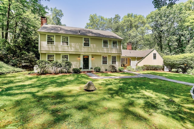 26 Heritage Ln, Weston, CT 06883 - colonial-style house featuring a chimney and a front lawn