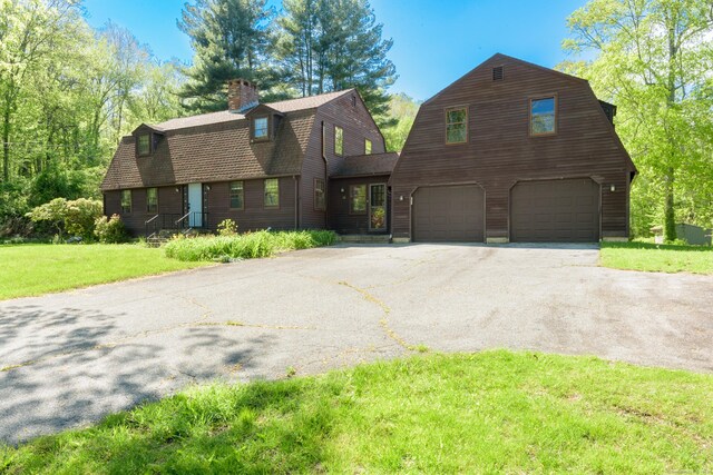 15 Haywardville Rd, East Haddam, CT 06423 - dutch colonial featuring a gambrel roof, driveway, an attached garage, a front yard, and a chimney