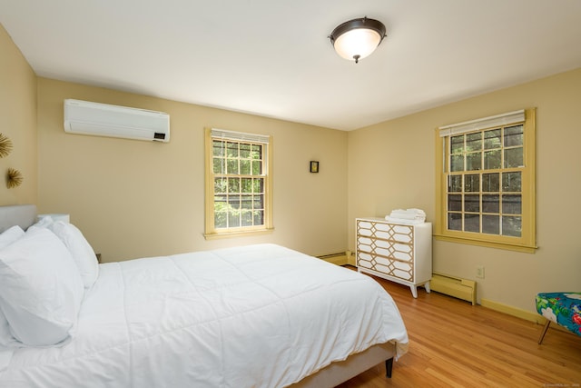 15 Haywardville Rd, East Haddam, CT 06423 - bedroom with a wall mounted AC, a baseboard heating unit, wood finished floors, and baseboards