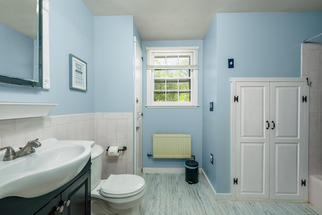 15 Haywardville Rd, East Haddam, CT 06423 - full bath with radiator, vanity, toilet, wood finished floors, and tile walls