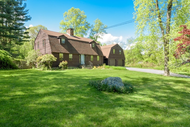15 Haywardville Rd, East Haddam, CT 06423 - dutch colonial featuring a gambrel roof, an attached garage, driveway, a chimney, and a front yard