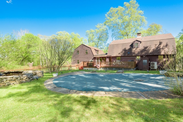 15 Haywardville Rd, East Haddam, CT 06423 - back of property featuring a gambrel roof, a deck, a chimney, and a patio area