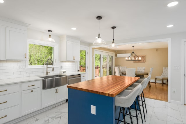 15 Haywardville Rd, East Haddam, CT 06423 - kitchen featuring a sink, light marble finish floors, butcher block countertops, recessed lighting, and a kitchen bar