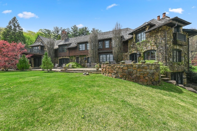 118 John St, Greenwich, CT 06831 - view of front of home featuring a chimney, a front lawn, and stone siding