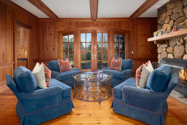 118 John St, Greenwich, CT 06831 - living room featuring wooden walls, french doors, beam ceiling, a fireplace, and hardwood / wood-style floors