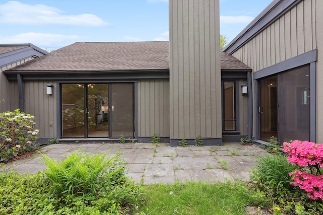 787 Heritage Vlg Unit A, Southbury, CT 06488 - rear view of property with a shingled roof, a patio, and a chimney