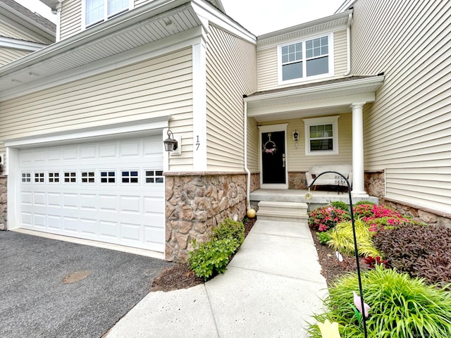 17 Highridge Rd Unit 17, Middlebury, CT 06762 - property entrance with stone siding, an attached garage, and driveway