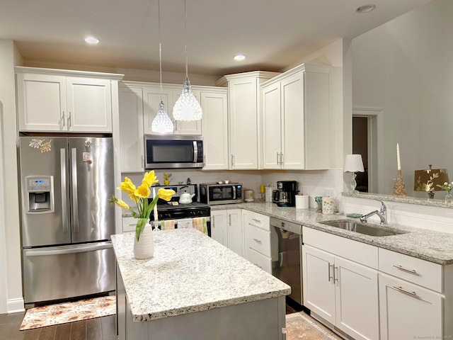 17 Highridge Rd Unit 17, Middlebury, CT 06762 - kitchen featuring stainless steel appliances, a sink, white cabinets, a center island, and light stone counters