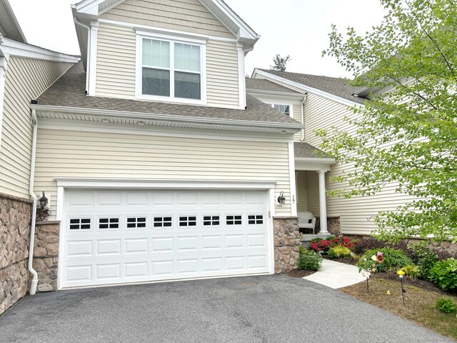17 Highridge Rd Unit 17, Middlebury, CT 06762 - traditional-style home featuring driveway, roof with shingles, stone siding, and a garage