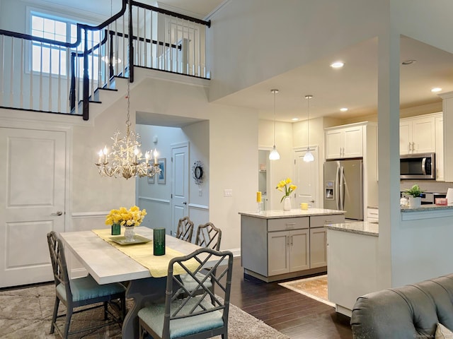 17 Highridge Rd Unit 17, Middlebury, CT 06762 - dining area featuring a towering ceiling, dark wood finished floors, recessed lighting, a chandelier, and baseboards