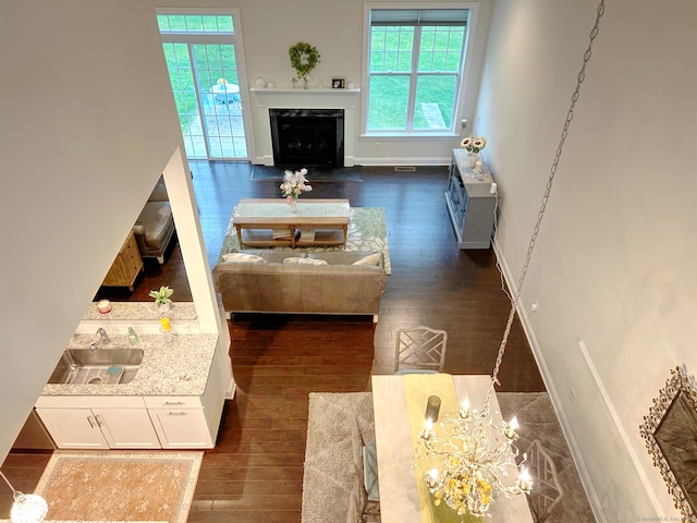 17 Highridge Rd Unit 17, Middlebury, CT 06762 - living room featuring dark wood finished floors, baseboards, a fireplace, and a chandelier