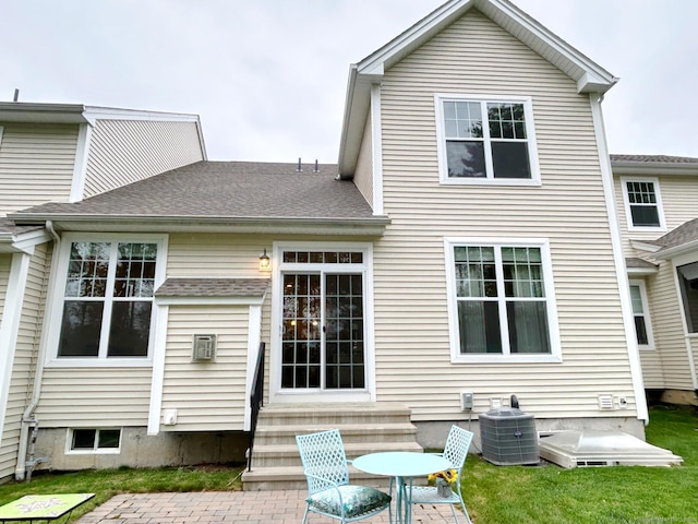 17 Highridge Rd Unit 17, Middlebury, CT 06762 - back of property featuring central air condition unit, entry steps, roof with shingles, and a patio area