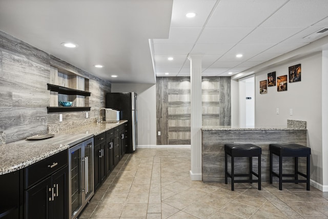 122 Mirey Dam Rd, Middlebury, CT 06762 - kitchen featuring dark cabinetry, beverage cooler, open shelves, recessed lighting, and a kitchen breakfast bar