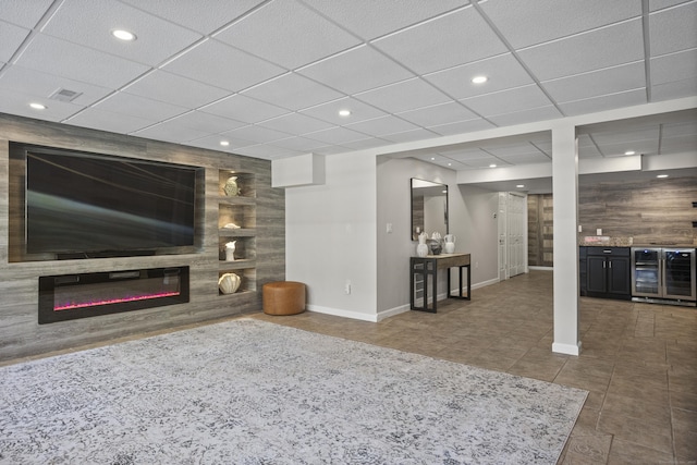 122 Mirey Dam Rd, Middlebury, CT 06762 - tiled living room featuring beverage cooler, baseboards, recessed lighting, a glass covered fireplace, and bar area