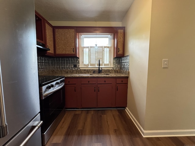 kitchen with stainless steel appliances, a sink, dark wood-type flooring, exhaust hood, and backsplash