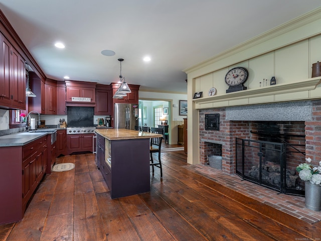 332 Good Hill Rd, Woodbury, CT 06798 - kitchen with reddish brown cabinets, stainless steel appliances, a sink, a center island, and hanging light fixtures