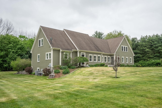 16 Miller Farms Rd, Willington, CT 06279 - view of front of home with a front yard, a shingled roof, and central AC