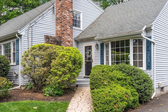 19 Edgewood St, Cromwell, CT 06416 - entrance to property featuring a chimney and roof with shingles